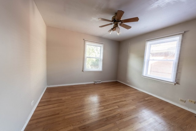 spare room featuring ceiling fan and hardwood / wood-style flooring