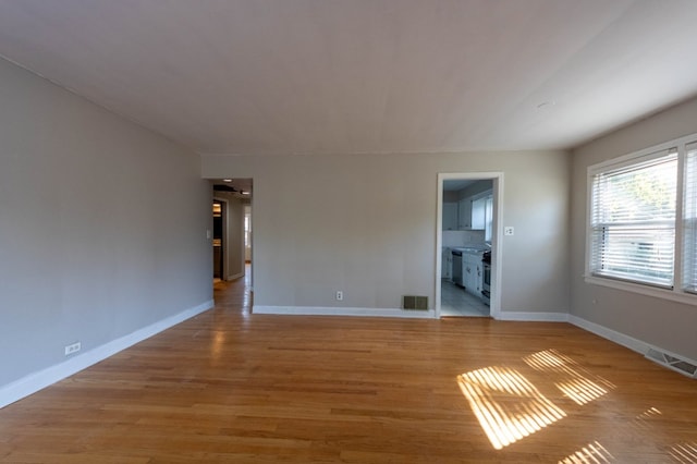 unfurnished living room featuring light wood-type flooring