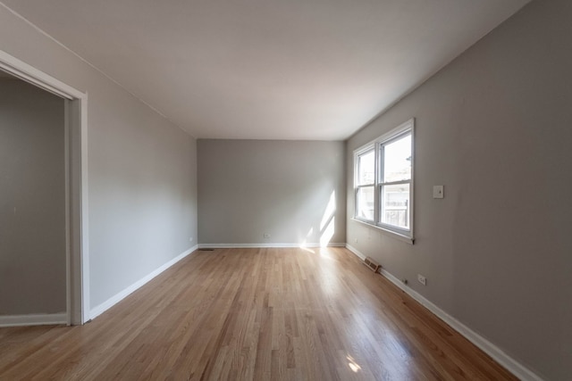 spare room with light hardwood / wood-style floors