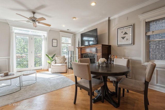 dining room with ornamental molding and hardwood / wood-style flooring