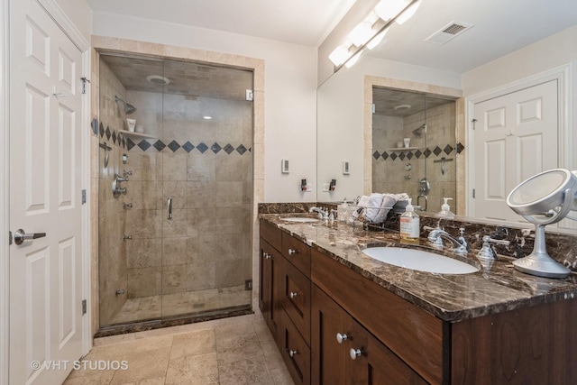 bathroom with walk in shower and vanity