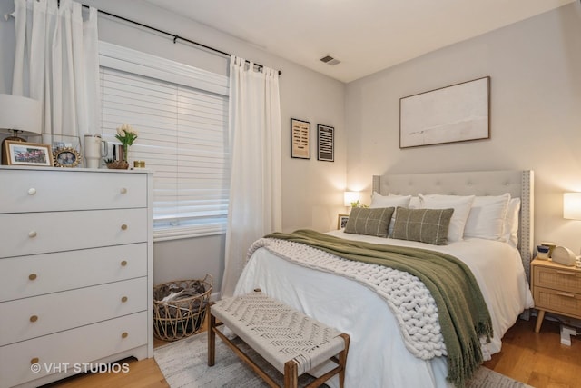 bedroom with hardwood / wood-style flooring