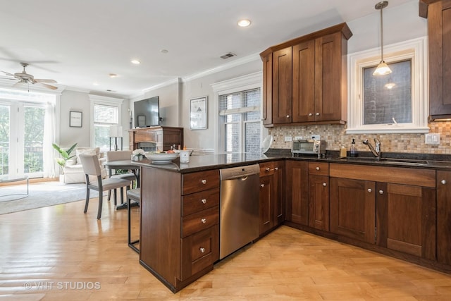 kitchen featuring sink, pendant lighting, dishwasher, and kitchen peninsula