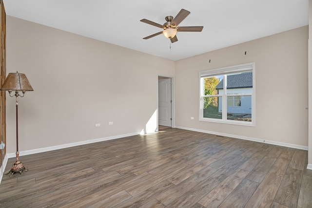 spare room featuring wood-type flooring and ceiling fan