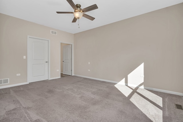 carpeted spare room with ceiling fan