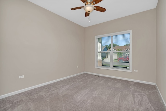 carpeted empty room featuring ceiling fan