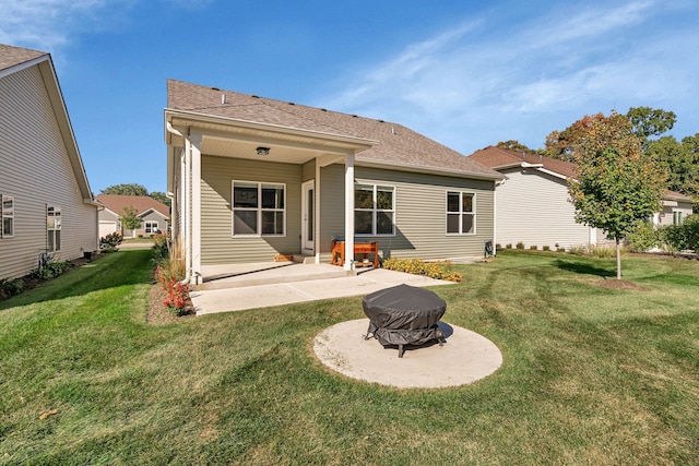 back of house with a lawn and a patio