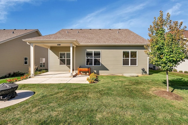 back of house featuring central AC unit, a lawn, and a patio