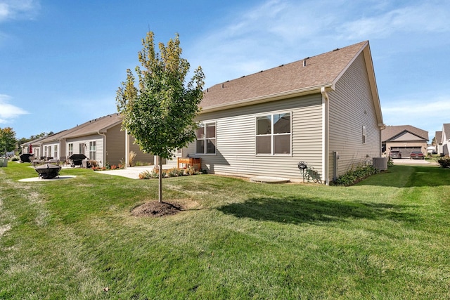 back of house with a lawn, a patio area, and central air condition unit