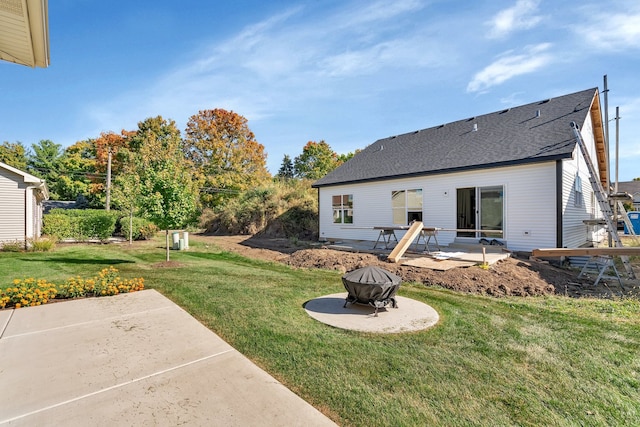 rear view of house featuring a lawn and a patio area