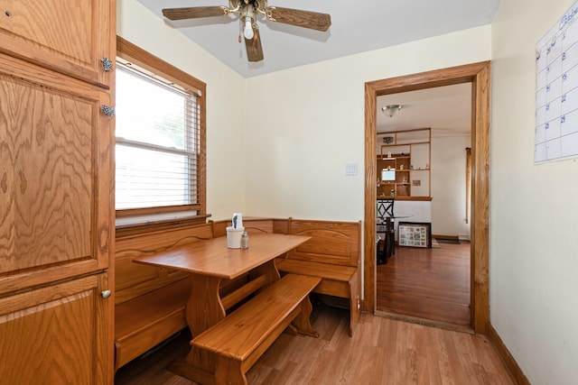 dining area with light wood-type flooring and ceiling fan