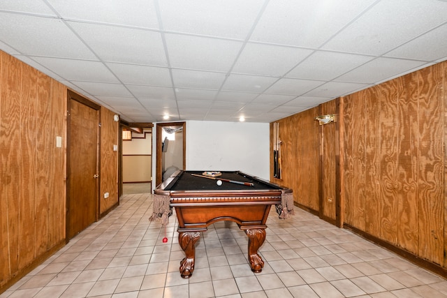 recreation room with pool table, a paneled ceiling, and wooden walls