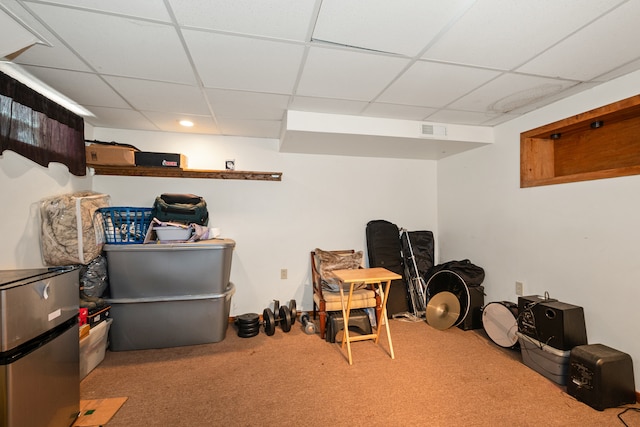 interior space featuring a paneled ceiling and carpet