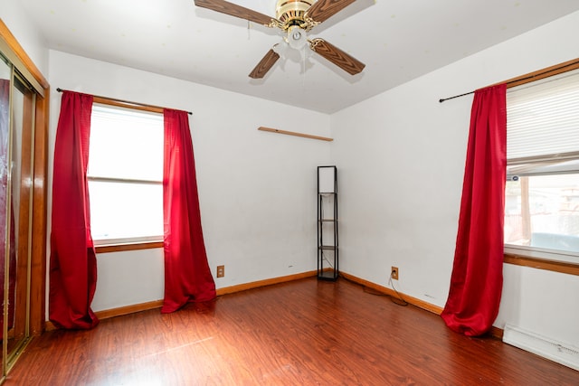 empty room featuring hardwood / wood-style flooring and ceiling fan