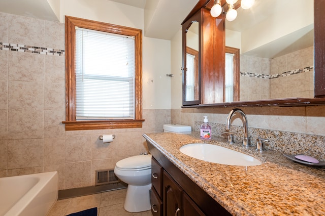 bathroom with tile patterned flooring, a bathtub, toilet, tile walls, and vanity