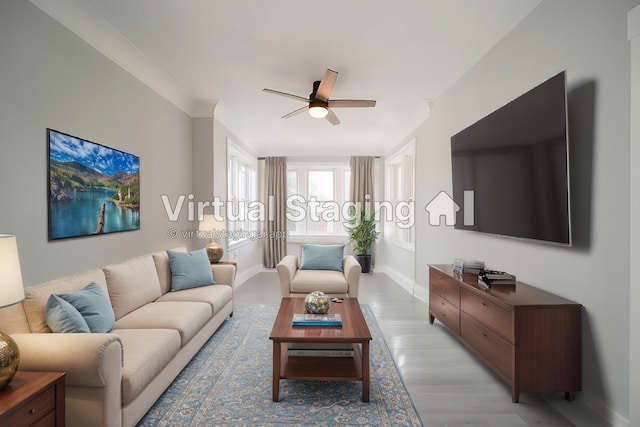 living room featuring ornamental molding, light hardwood / wood-style floors, and ceiling fan