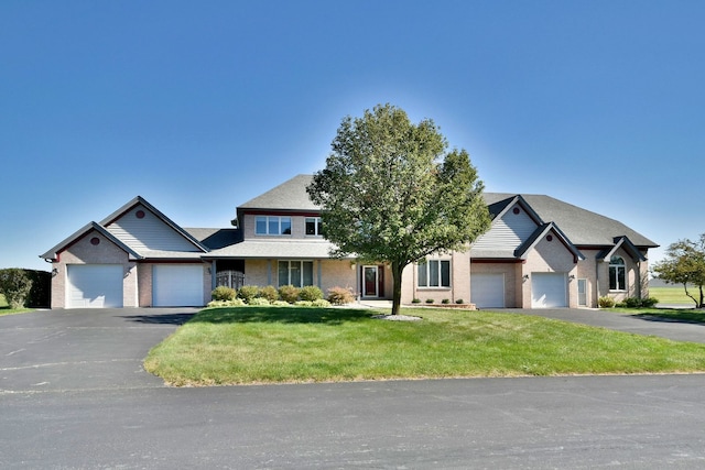 view of front of property with a front lawn and a garage