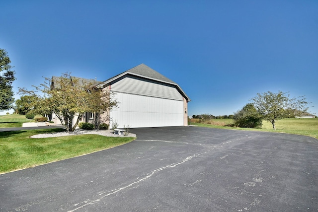 view of front of house featuring a garage and a front lawn