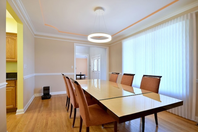 dining area featuring light hardwood / wood-style flooring and ornamental molding