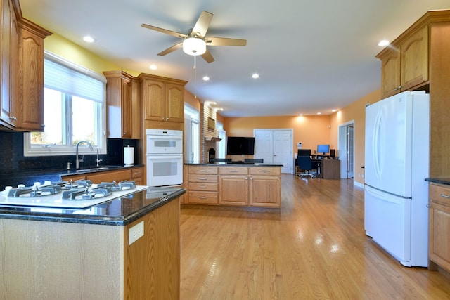 kitchen with ceiling fan, sink, white appliances, tasteful backsplash, and light hardwood / wood-style floors