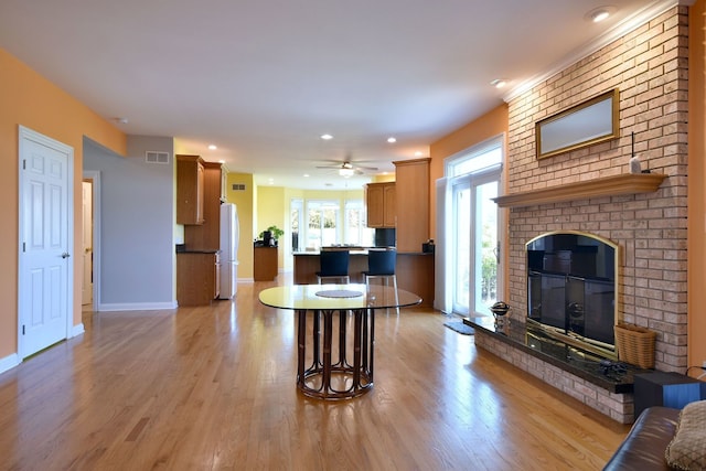 living room featuring ceiling fan and light hardwood / wood-style floors