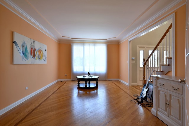 interior space with ornamental molding and light hardwood / wood-style flooring