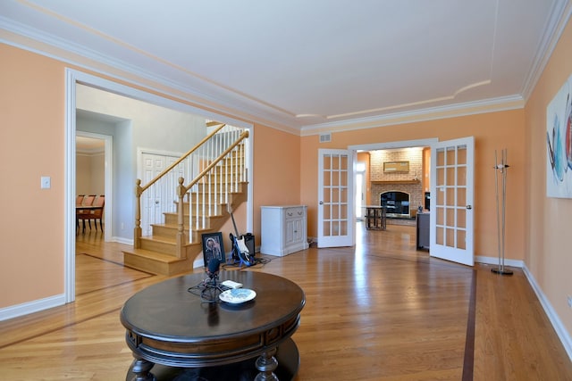 living room with french doors, hardwood / wood-style floors, and ornamental molding