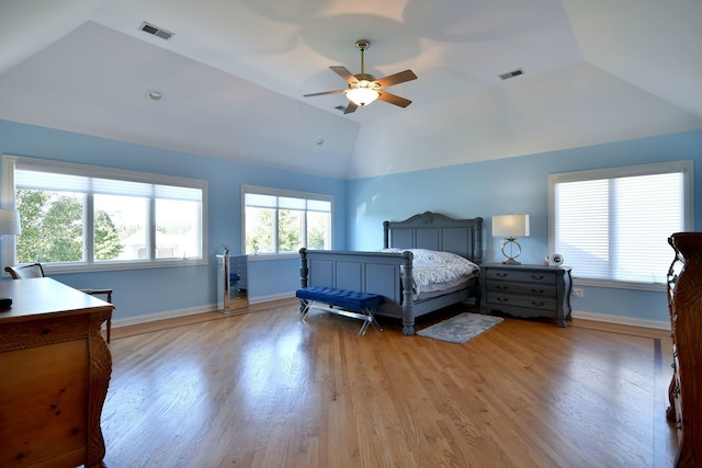 bedroom featuring light hardwood / wood-style floors, vaulted ceiling, and ceiling fan