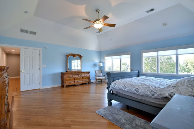 bedroom with hardwood / wood-style flooring, high vaulted ceiling, and ceiling fan