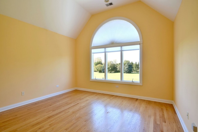 unfurnished room featuring vaulted ceiling and light hardwood / wood-style floors