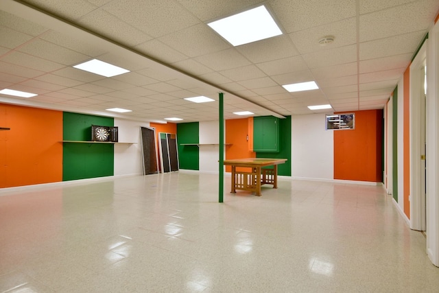 interior space with a paneled ceiling