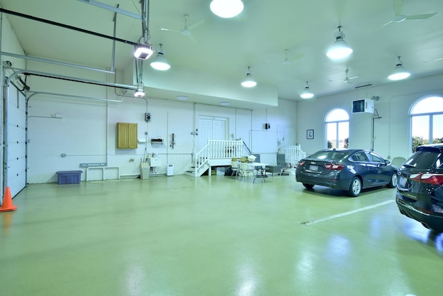 garage with a garage door opener and ceiling fan