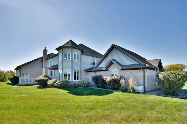 rear view of house with a lawn