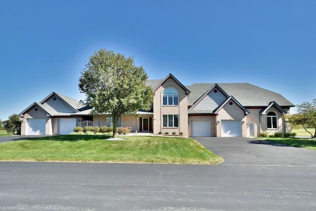 view of front of house with a front yard and a garage