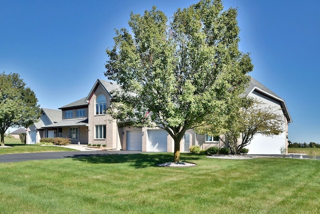 view of front of home with a garage and a front lawn