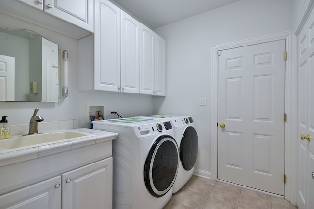 laundry area featuring cabinets, sink, light tile patterned floors, and independent washer and dryer