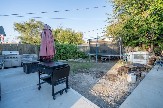 view of patio featuring grilling area and a trampoline