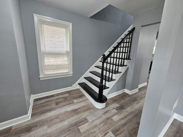 stairs with wood-type flooring