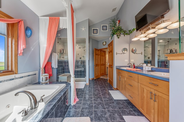 bathroom featuring vanity, lofted ceiling, tile patterned flooring, and plus walk in shower