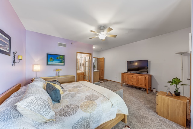 carpeted bedroom featuring ensuite bath and ceiling fan