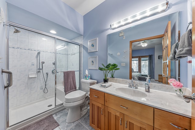 bathroom with ceiling fan, toilet, vanity, an enclosed shower, and tile patterned flooring