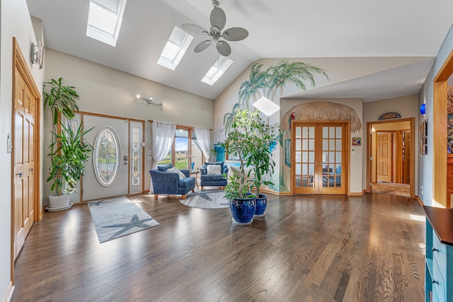 foyer entrance with french doors, lofted ceiling with skylight, dark wood-type flooring, and ceiling fan