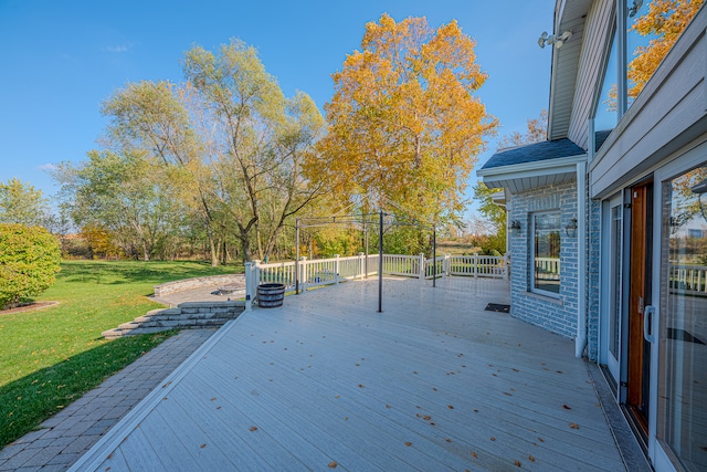 wooden terrace with a gazebo and a lawn