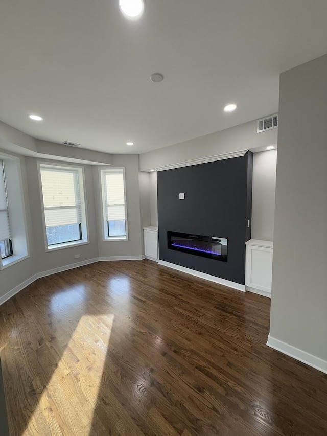 unfurnished living room with dark wood-type flooring