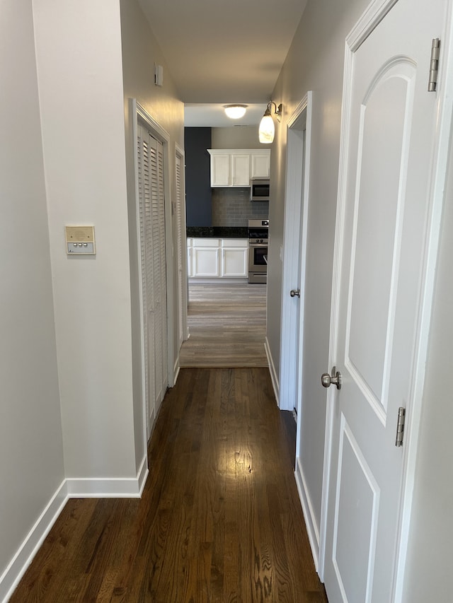 hallway with dark wood-type flooring