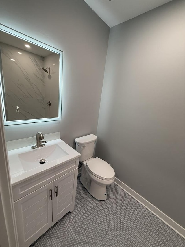 bathroom featuring walk in shower, vanity, and toilet