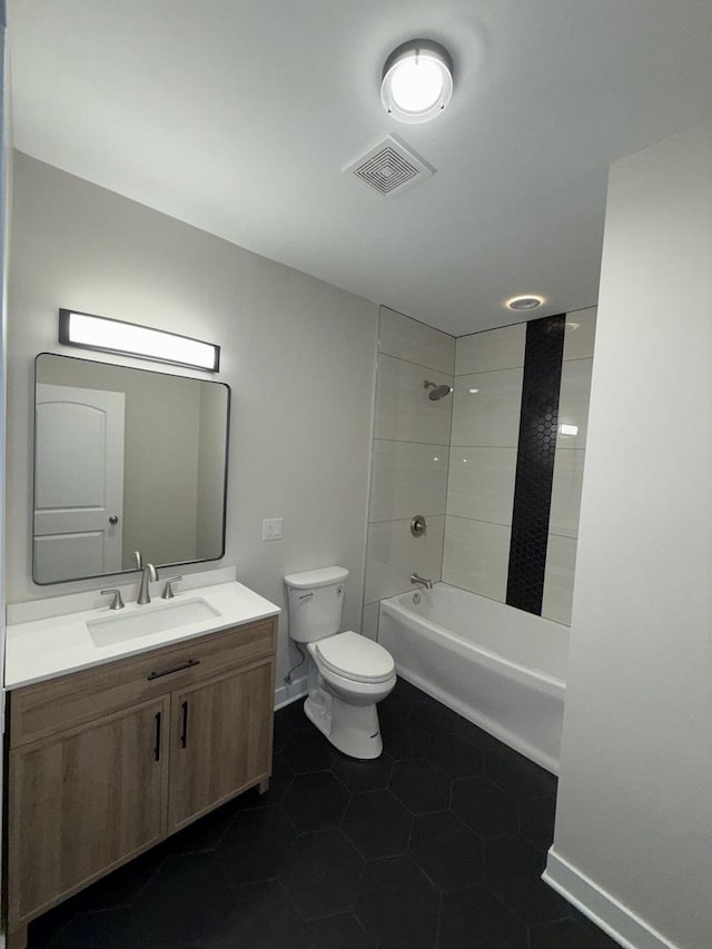 full bathroom with tile patterned floors, vanity, tiled shower / bath combo, and toilet