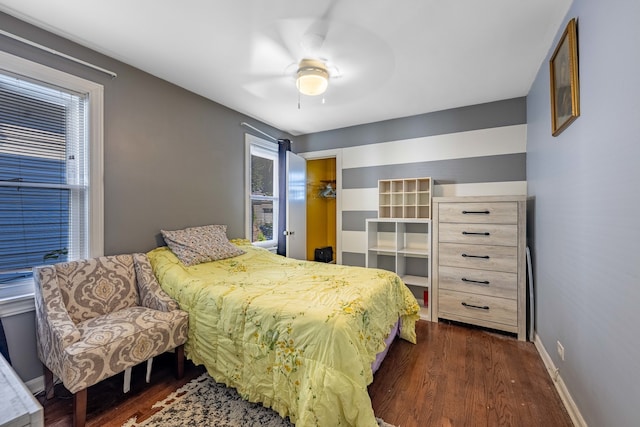 bedroom with dark hardwood / wood-style floors and ceiling fan