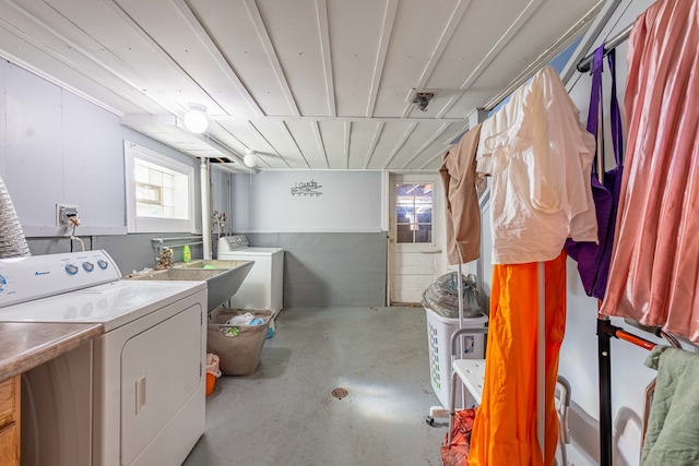 clothes washing area featuring sink and washing machine and clothes dryer