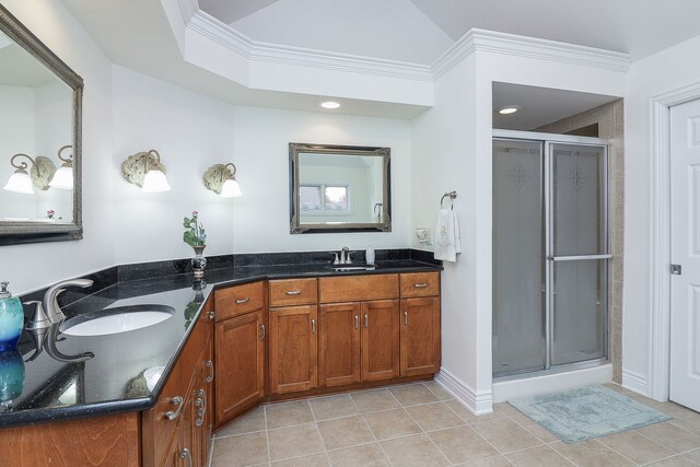 bathroom featuring walk in shower, vanity, tile patterned flooring, and ornamental molding